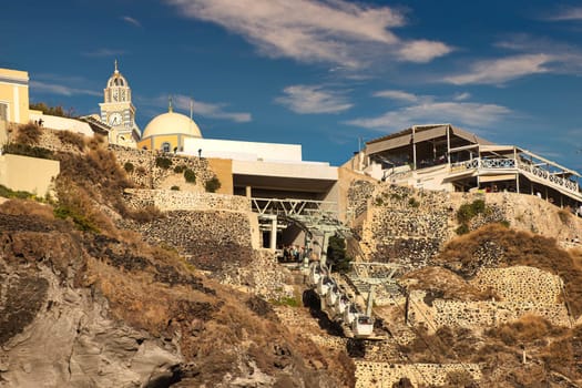 SANTORINI, GREECE - October 23, 2024: Buildings Over funicular in Santorini Greece