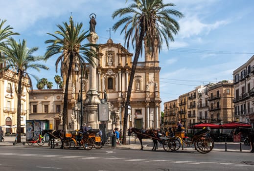 PALERMO, ITALY - October 24, 2024: Horses and Carriages at Church in Palermo Italy