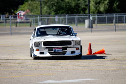 September 11, 2016 - Boise, Idaho: A white classic mustange is driving on a track with a cone in the middle.