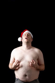 A man with a Santa hat on his head making a funny face