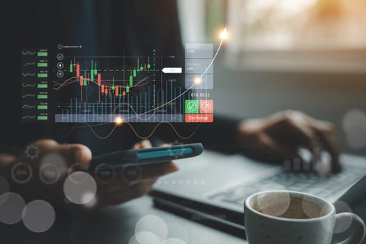 Businessman checking stock market trends and currency exchange rates on laptop and mobile phone. Economic growth and finance concept. checking stock market graph report analysis