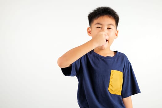 Asian young child unhappy what a smell disgust expression squeezing nose with fingers. Kid boy primary have something stinks bad smell situation, studio shot isolated on white background, Healthcare