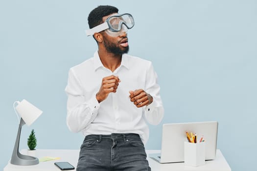 Confident young African American man in formal attire with safety goggles, performing scientific demonstration or experiment at workplace, emphasizing innovation, technology, research, and learning environment. Concept: STEM education.