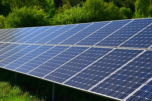 Solar power plant - concept for electricity and ecological industry. High energy prices. Beautiful landscape and sunny day with blue sky. Photovoltaic power plant.