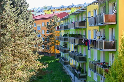 Facade of a modern apartment building with windows and balconies. Czech Republic - Europe.. Original prefabricated houses on a housing estate from the communist era in Eastern and Central Europe after reconstruction.. 