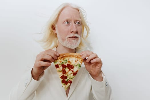 A striking image of a man with white hair and a beard, dressed in a unique white suit, holding a slice of pizza The plain light background highlights his features and the pizza, creating an intriguing contrast