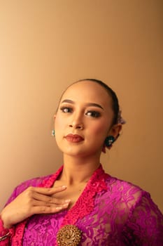 Asian woman touching her neck and feeling sexy with herself while posing inside the cream room