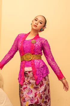 Beautiful bride from Balinese woman with pink dresses and make up on her face before the ceremony began