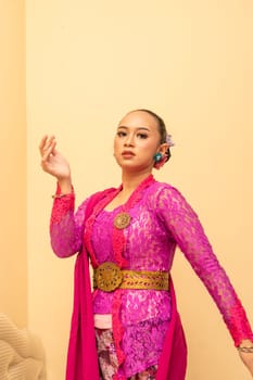 Javanese woman wearing traditional pink dress called kebaya on the Indonesian independence day