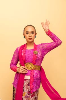 Javanese woman wearing traditional pink dress called kebaya on the Indonesian independence day