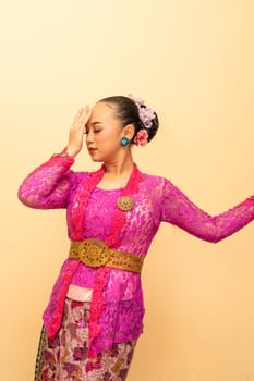 Javanese woman wearing traditional pink dress called kebaya on the Indonesian independence day
