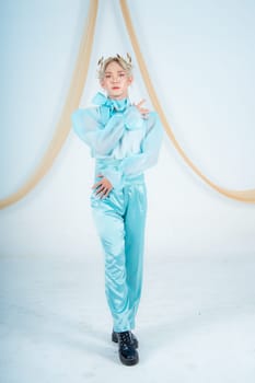 an Asian woman posing elegantly in a blue costume in a white room