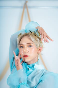 beautiful face of an asian woman with red lipstick and blue eyes in a white studio