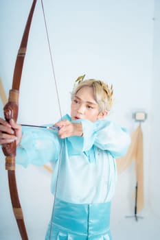 a princess in a blue dress pulling a bow with her hand in a white room