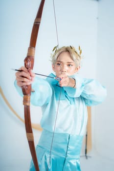 a princess in a blue dress pulling a bow with her hand in a white room