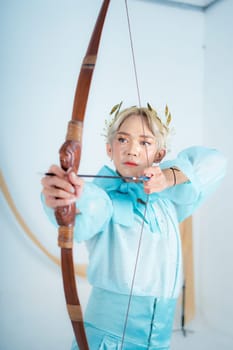 a princess in a blue dress pulling a bow with her hand in a white room