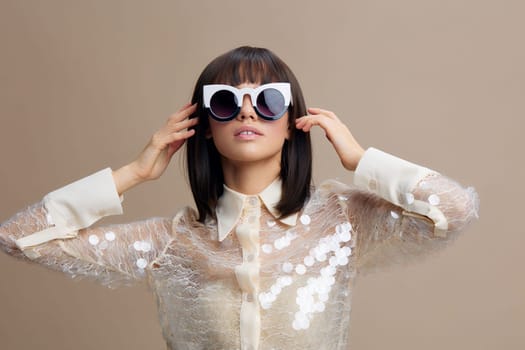 Woman, sequinned shirt, sunglasses a woman in a sequinned shirt and sunglasses smiles at the camera with her hands on her head, exuding confidence and joy