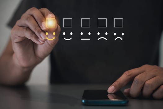 Customer's hand holding smartphone, giving 5-star rating feedback for excellent service. Satisfaction survey, review and feedback concept for business success