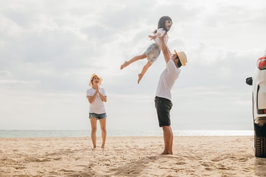Happy family three playing on sandy beach, Parents father holding child on his shoulders jump their children flying to air, holiday vacations summer road trip, Family day enjoying their time together