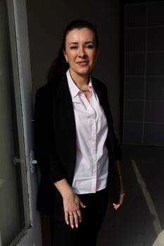 Brunette 40 years old in a business suit posing nice