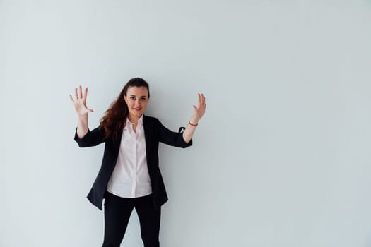 Brunette woman in business suit showing her hand 10 fingers on white background