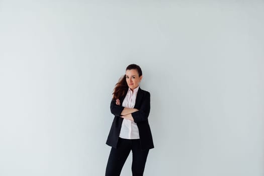 Brunette woman in business suit posing on white background