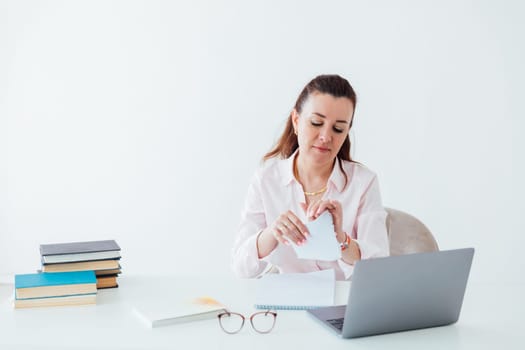 Brunette woman working at office desk with laptop online