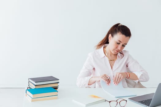 Brunette woman working at office desk with laptop online