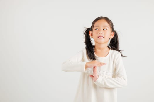 Closeup portrait young kid girl smiling making give time out gesture with hands studio shot isolated on white background, kindergarten child demonstrates break hand sign, stop time with copy space