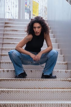 African American woman dancing in a creative pose between benches in an urban setting. he wears casual clothes and shows balance,strength, and expression. Concept of movement, art,and freedom.Vertical