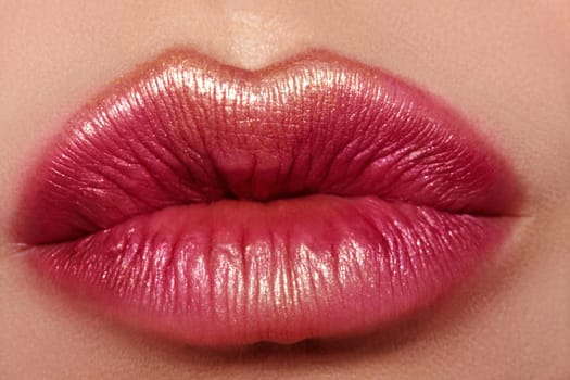 Macro close-up glamour fashion bright red lips make-up with gold glitter. Macro of woman's face part. Sexy lip makeup, luxury visage