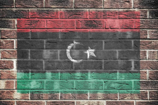 A Libya flag on brick wall background