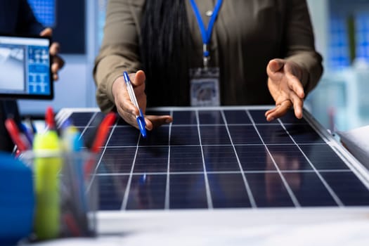 Scientists conduct research and development on solar panel efficiency, analyzing photovoltaic materials in high tech factory to enhance renewable energy production, close up shot