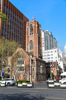 Shanghai, China - 1 April 2025: Mu'en Church near People's Park, a neo-Gothic red brick church, stands among modern buildings in central Shanghai