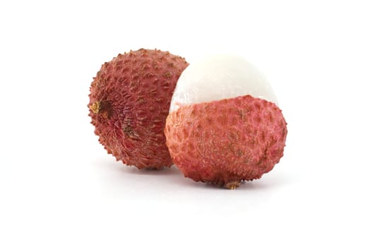 Fresh ripe lychee fruit with vibrant red skin and a glossy peeled interior, isolated on white background
