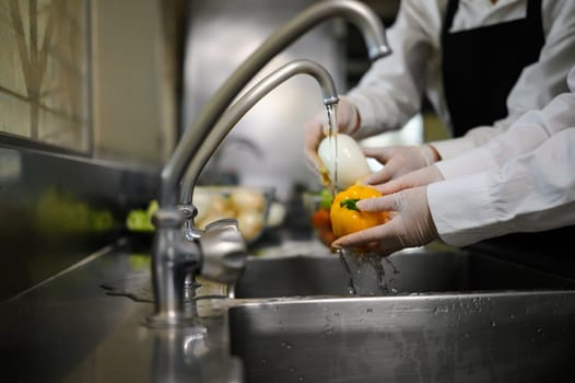Culinary students washing produce in a cooking school.