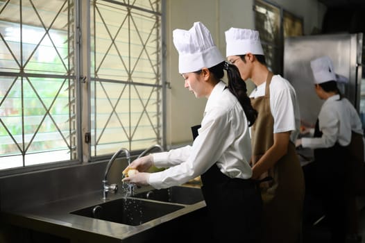 Culinary students washing produce in a cooking school.