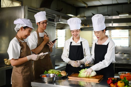 Cooking school teacher instructs students on vegetable cutting techniques in a kitchen.