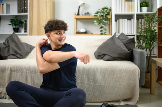 Young caucasian man preparing for a workout in a bright, modern room.