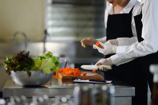 Culinary students washing produce in a cooking school.