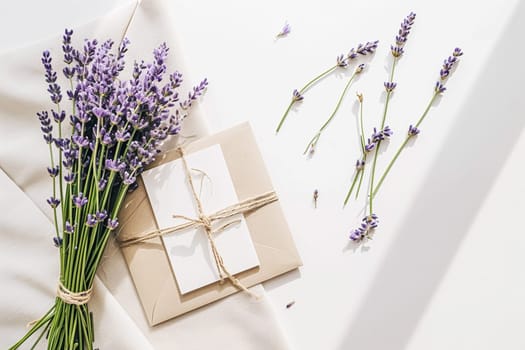 Elegant lavender-themed stationery set with invitation, envelope tied with ribbon, and loose lavender sprigs.