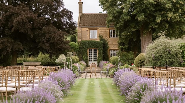 Aisle with wooden chairs and purple lavender floral decorations at an outdoor wedding ceremony in the garden