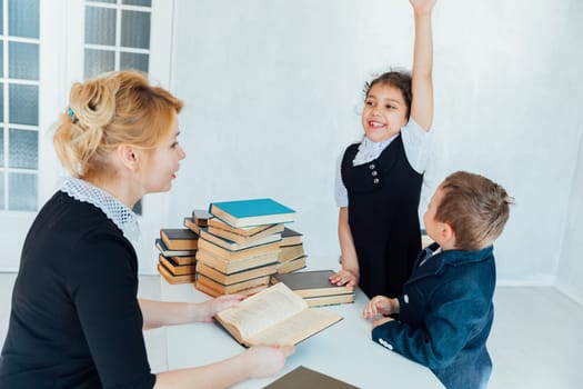Teacher Conducting Lesson with Book for Children in School Classroom