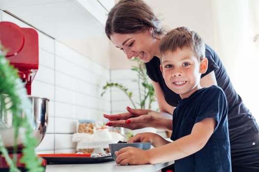 Woman with son preparing food in the kitchen sweet dessert