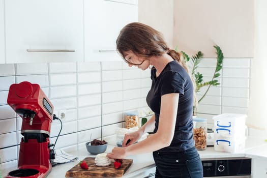Woman housewife preparing food in the kitchen sweet dessert