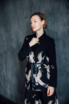 Fashionable woman 40 years old in black suit portrait