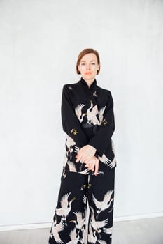Fashionable woman 40 years old in black suit portrait