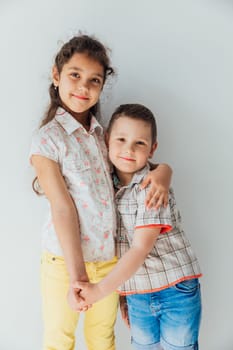 Boy And Girl Hugging And Smiling On White Background