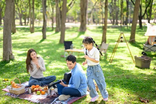 Family spending quality time together at a sunny campsite.