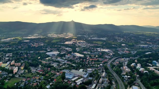 A stunning aerial shot vividly capturing a breathtaking landscape, adorned with beautiful rays of sunlight